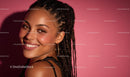 Smiling Woman with Braided Hair on Pink Background