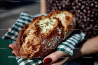 Artisanal Loaf with Golden Crust and Fresh Herbs