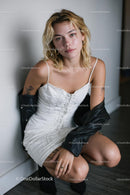 Elegant Young Woman in White Dress with Leather Jacket