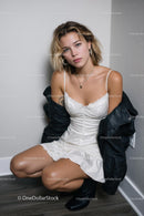 Fashionable Woman in White Dress with Black Jacket