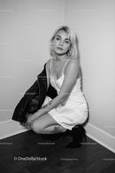 Elegant Woman in White Dress with Leather Jacket