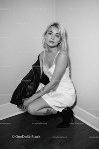 Elegant Woman in White Dress with Leather Jacket