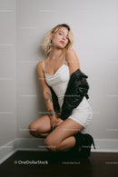 Stylish Woman in White Dress with Leather Jacket