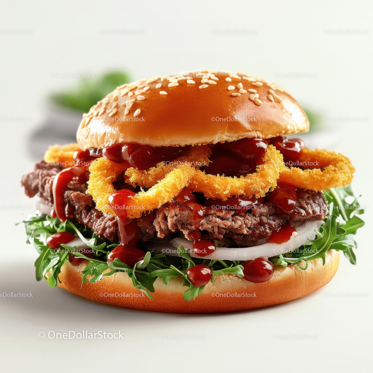 Gourmet Steak Burger with Onion Rings and Arugula