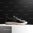 Minimalist Black Shoe on White Pedestal with Modern Design