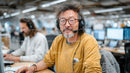 Smiling Customer Service Agent in Modern Office