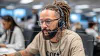Customer Support Agent Wearing Headset in Modern Office