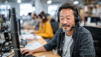 Man in Headset Working at Modern Office Desk
