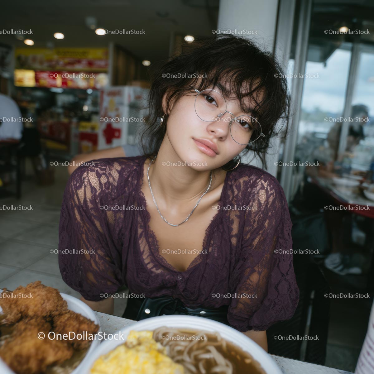 Young Woman with Purple Lace Top Dining in Urban Eatery
