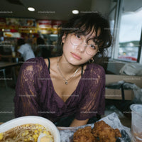 Young Woman with Purple Lace Top Dining in Urban Eatery