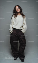 Woman in Cozy Sweater and Brown Pants Posing Confidently