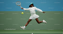 Energetic Female Tennis Player Jumping on Court