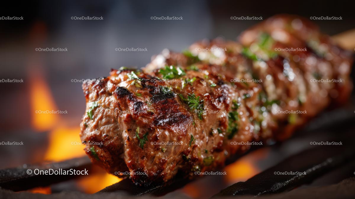 Juicy Grilled Steak with Fresh Herbs on Barbecue