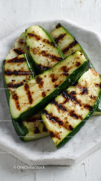 Grilled Zucchini Slices on a White Plate
