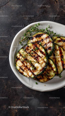 Grilled Zucchini Slices with Fresh Thyme on White Plate