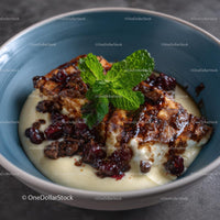 Decadent Dessert with Mint Sprig and Raspberry Topping