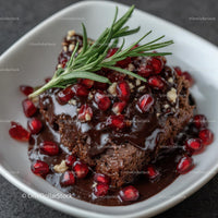 Rich Chocolate Cake with Pomegranate and Rosemary Garnish