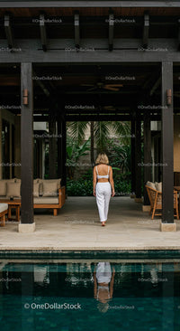 Woman Enjoys Solitude in Tropical Villa with Pool
