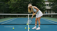 Female Tennis Player on Outdoor Court Picking Up Balls