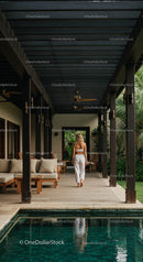 Woman Walking in Luxury Villa with Pool and Patio