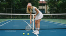 Female Tennis Player Concentrates on the Court