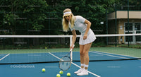 Female Tennis Player on Outdoor Court Preparing Shots
