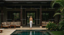 Woman Walking by Tranquil Pool in Tropical Villa