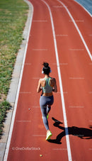 Athletic Woman Running on Outdoor Track
