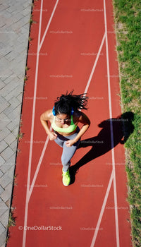 Woman Jogging on Red Running Track Outdoors