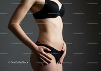 Slim Woman with Toned Abs in Black Lingerie Studio Portrait