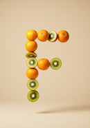 Letter F made of fresh oranges and kiwi slices