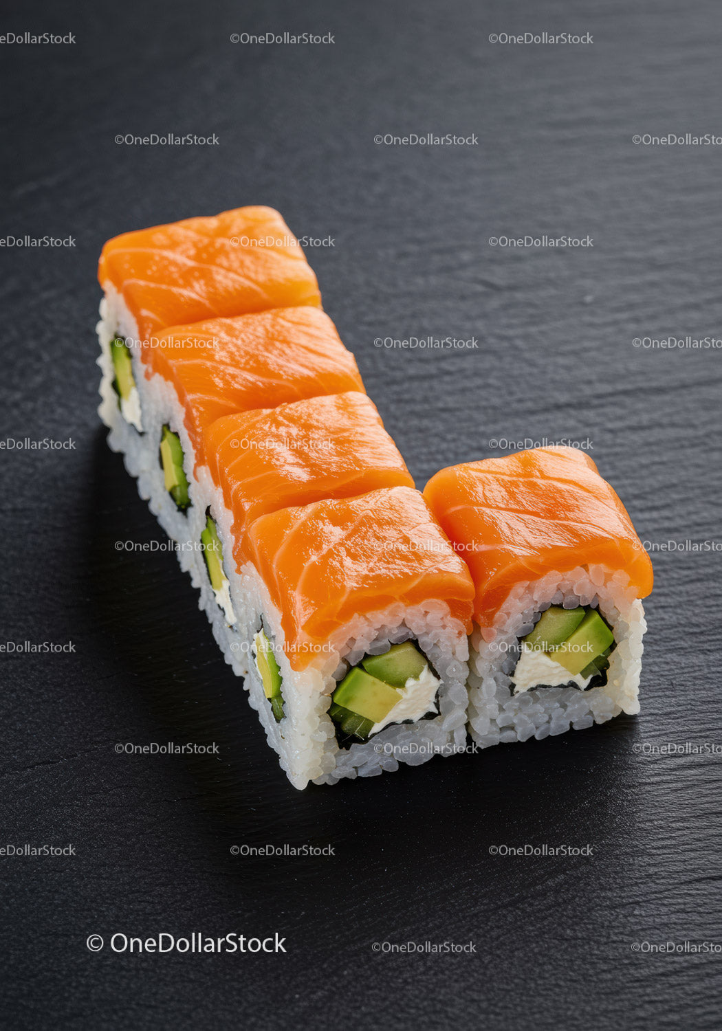 Fresh Salmon Avocado Sushi Rolls on Black Slate