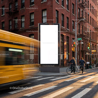 Urban street corner with bus and cyclists near billboard