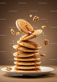 Stack of fluffy pancakes dripping with syrup and walnuts
