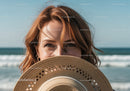 Joyful Woman with Straw Hat at the Beach in Bright Summer Sunlight