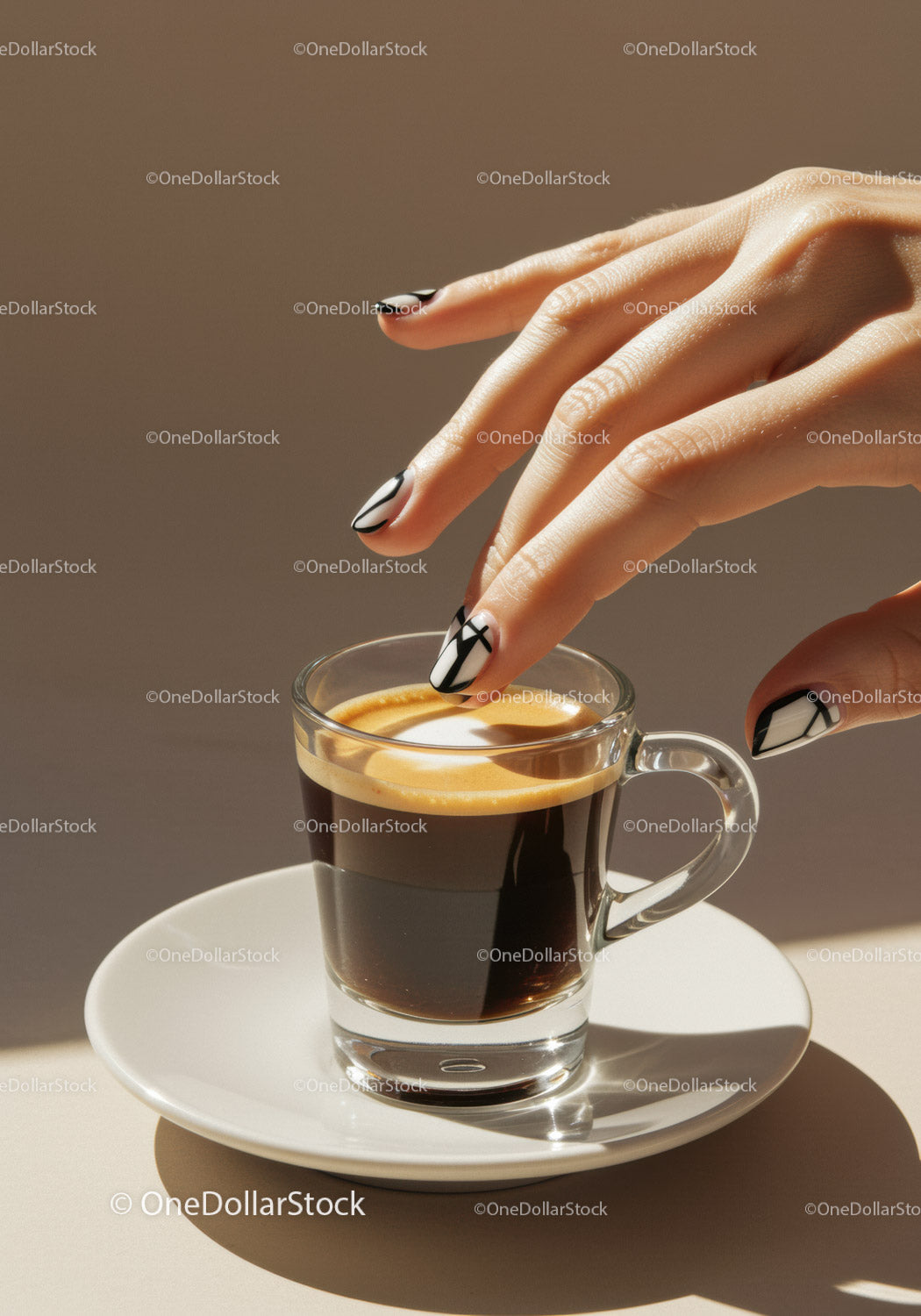 Hand with Modern Black and White Nails Reaching Espresso Cup