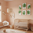 Modern nursery with Tropical Monstera Leaf Wall Art and Wooden Baby Crib