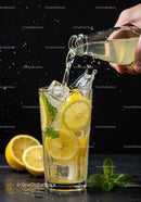 Refreshing Lemonade with Mint and Ice Splashing in Glass