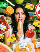 Young Woman Enjoying Popsicle Among Fresh Fruits In Store