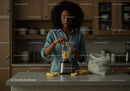 Woman Preparing Fruit Smoothie in Modern Kitchen
