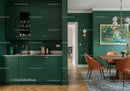 Elegant Green Kitchen and Cozy Dining Area with Artful Decor