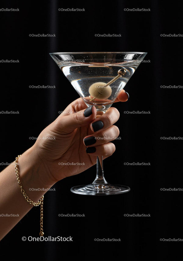 Hand Holding Classic Martini Glass with Olive