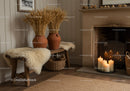 Cozy rustic corner with candles and dried wheat decor