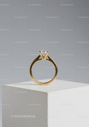Elegant Gold Ring with Solitaire Diamond on White Pedestal