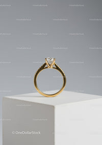 Elegant Gold Ring with Solitaire Diamond on White Pedestal
