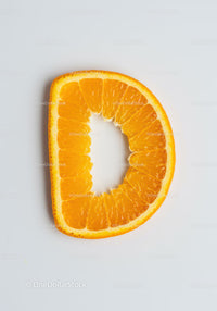Fresh orange slice shaped like letter D on white background