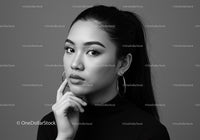 Elegant Black and White Portrait of a Confident Woman with Hoop Earrings