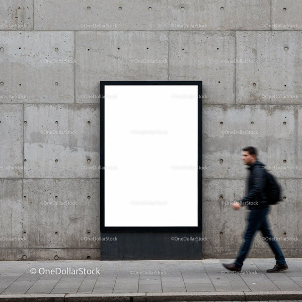 Man walking past blank urban advertising board on concrete wall JPG Mockup Image