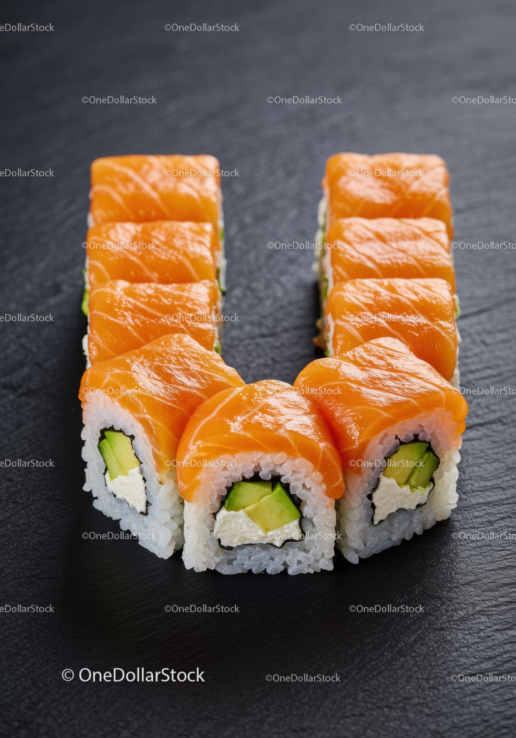 Fresh salmon sushi rolls arranged in a U shape