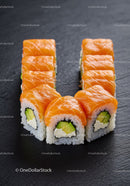 Fresh salmon sushi rolls arranged in a U shape